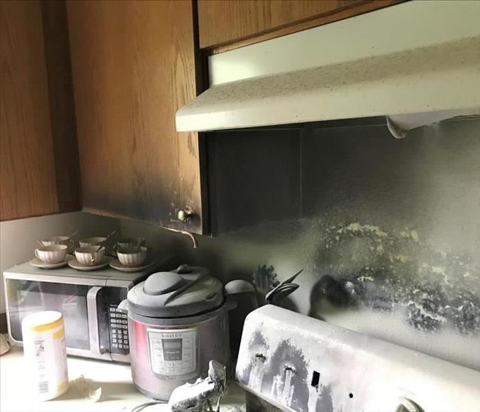 Small kitchen fire smoke damage in residence