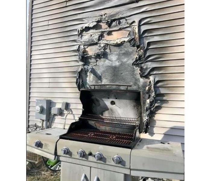 Grill fire damage exterior of home