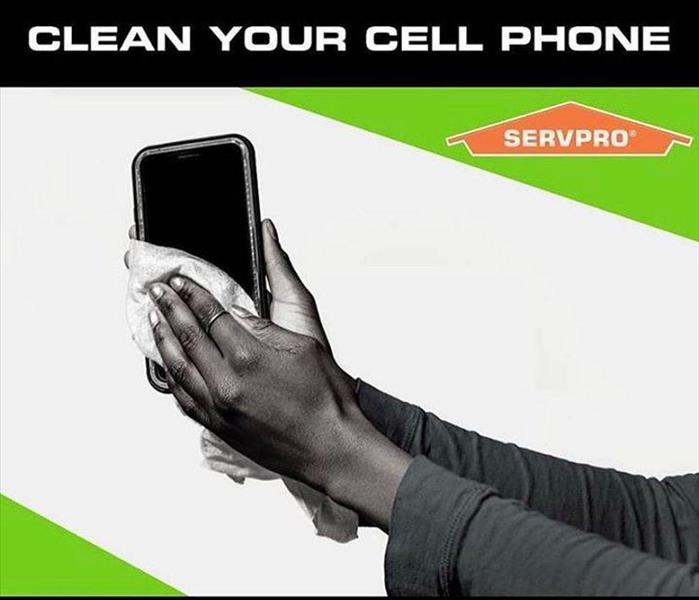 Hand holding phone with Servpro application 
